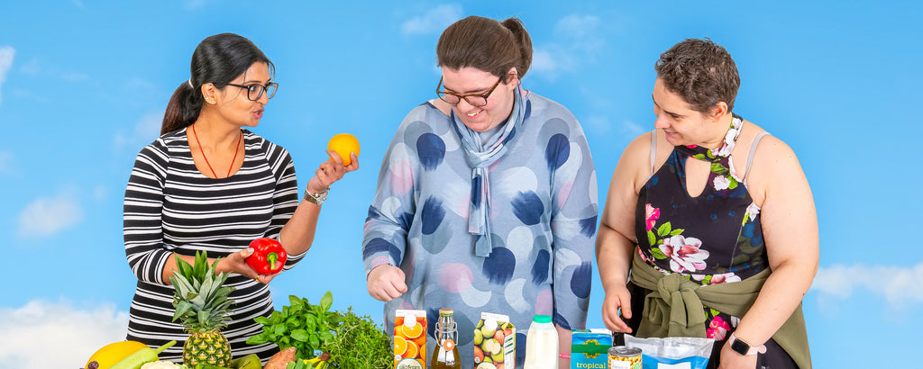 3 women looking at a range of healthy vegetables