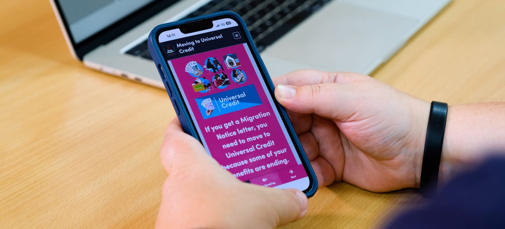A view of a mobile phone in a person's hands showing some digital Easy Read