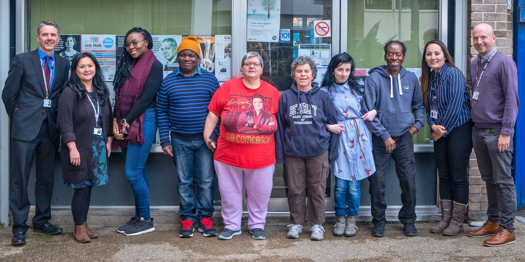 A group photo of Photosymbols Actors and volunteers from the Care Quality Commission. From a photoshoot with Camden People First. Everyone is outside the office.