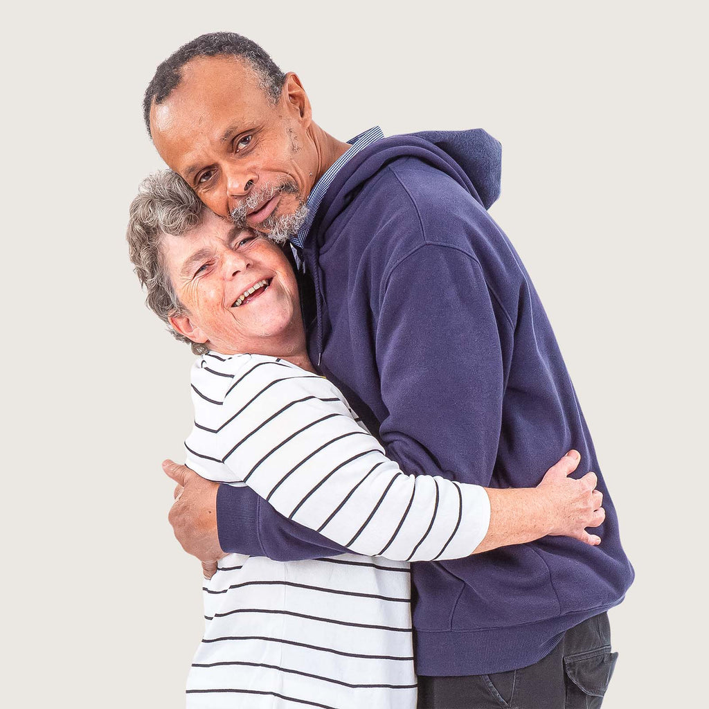 Bonnie and Kingsley - A black man and a white woman. They are a couple and are happily hugging.