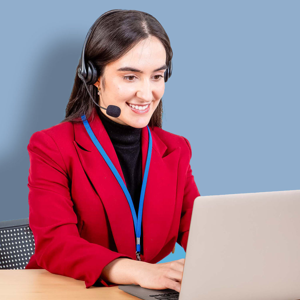 Woman wearing a telephone headset is typing on the computer.