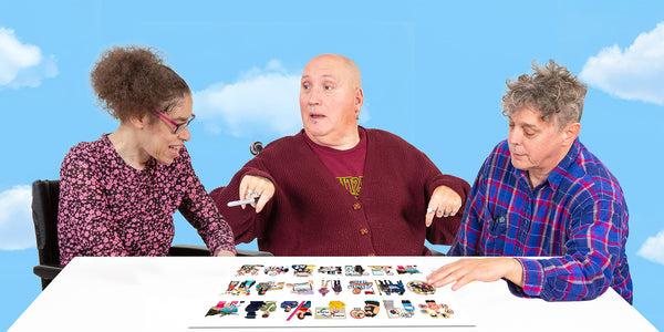 Expert advisers Michaela and Matt chat to Pete about some Photosymbols on a piece of paper on a desk.