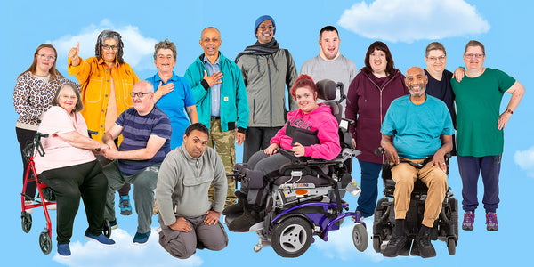 A varied group of Photosymbols actors smile in a group scene.