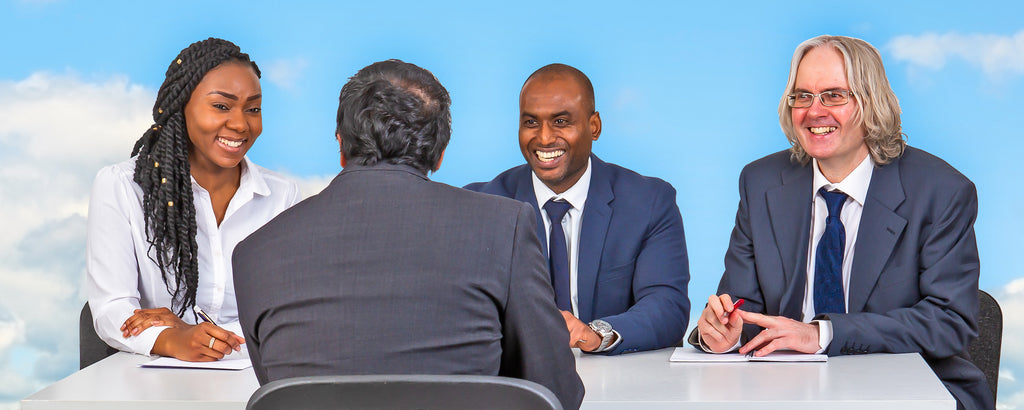 A man is being interviewed by 3 people